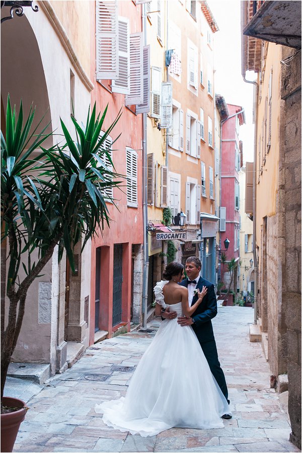 Bride and Groom pose for photos on quiet lane in Grasse
