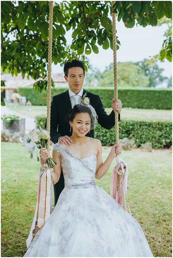 Bride Groom on a swing in rustic French countryside