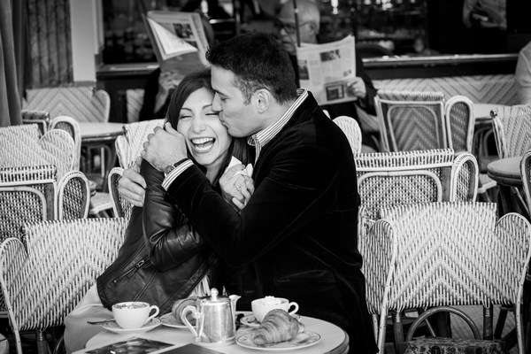 Paris Photographer couple having fun in typical Parisian cafe