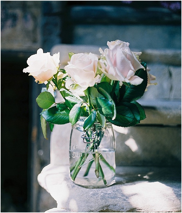 white roses in a jam jar