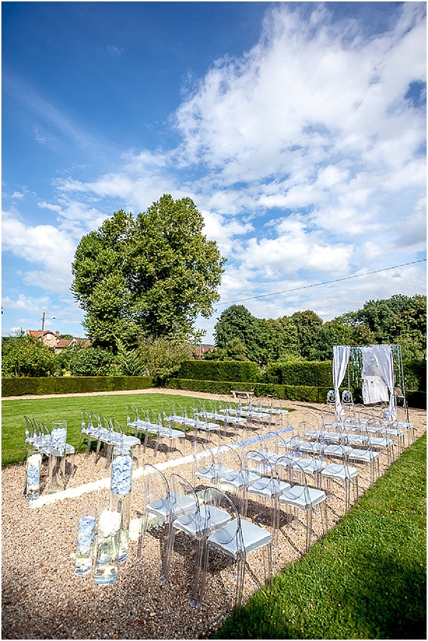 clear chairs outdoor ceremony