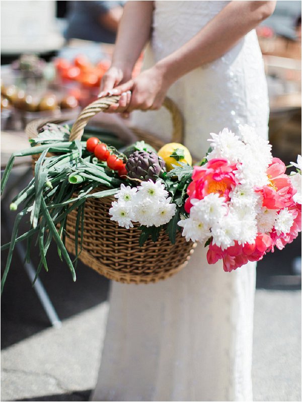 Bride carries basket of fresh local produce in Provence