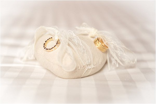 Gold wedding rings presented with lace