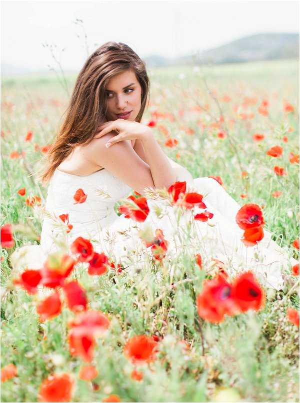 Stunning bride amongst a wild poppy field in provence