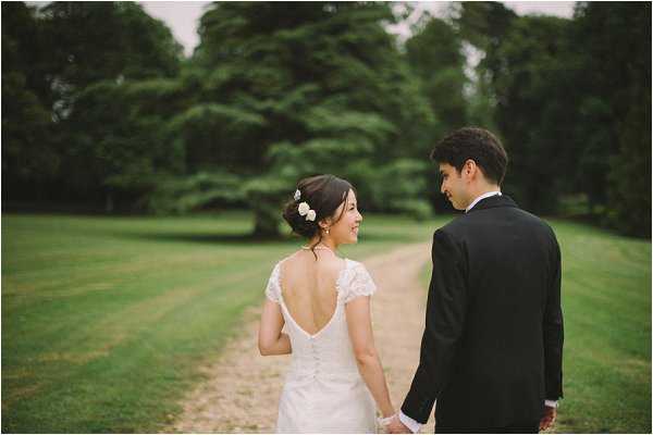 Bride and groom enjoy a stroll through the chateau grounds