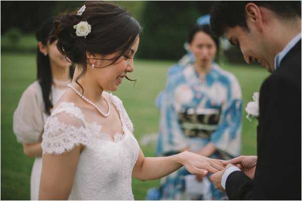 Exchanging rings in outdoor ceremony at Chateau de Baronville