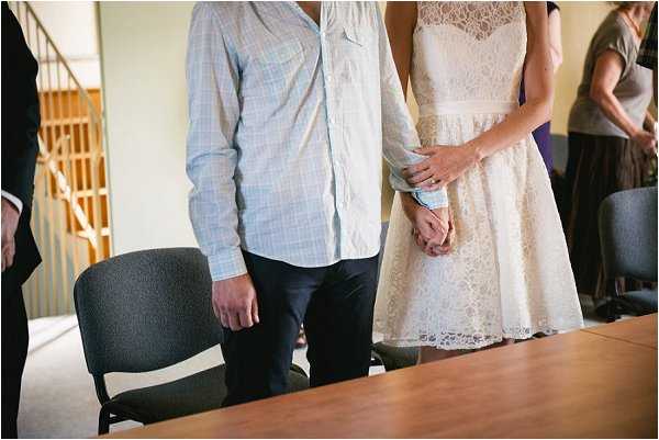 Bride and groom hold hands at their french wedding ceremony