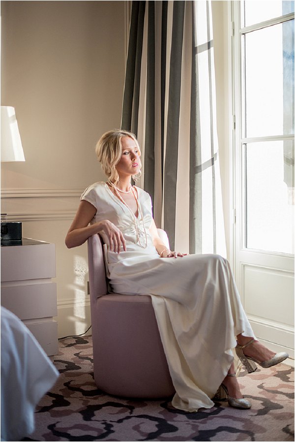 Bride relaxing by the window before the ceremony