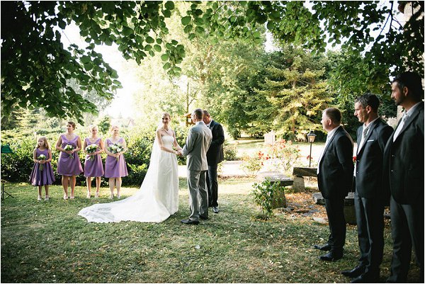 Bridesmaids and Groomsmen observe the vows