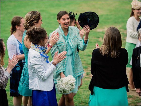 Delighted wedding guest catches the bouquet