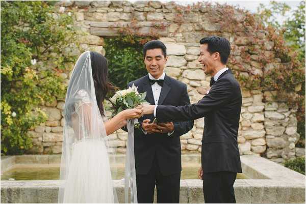 Exchanging rings in outdoor wedding ceremony in Provence