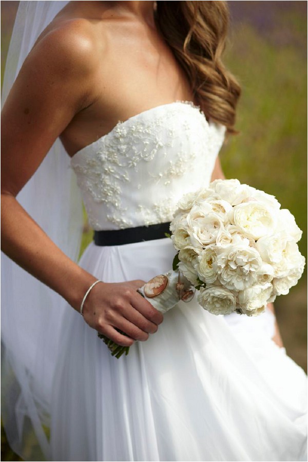 classic bridal look with black belt and white bouquet