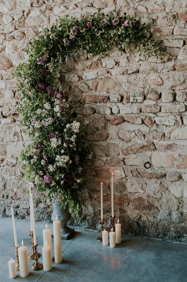 candles and flowers wedding arch