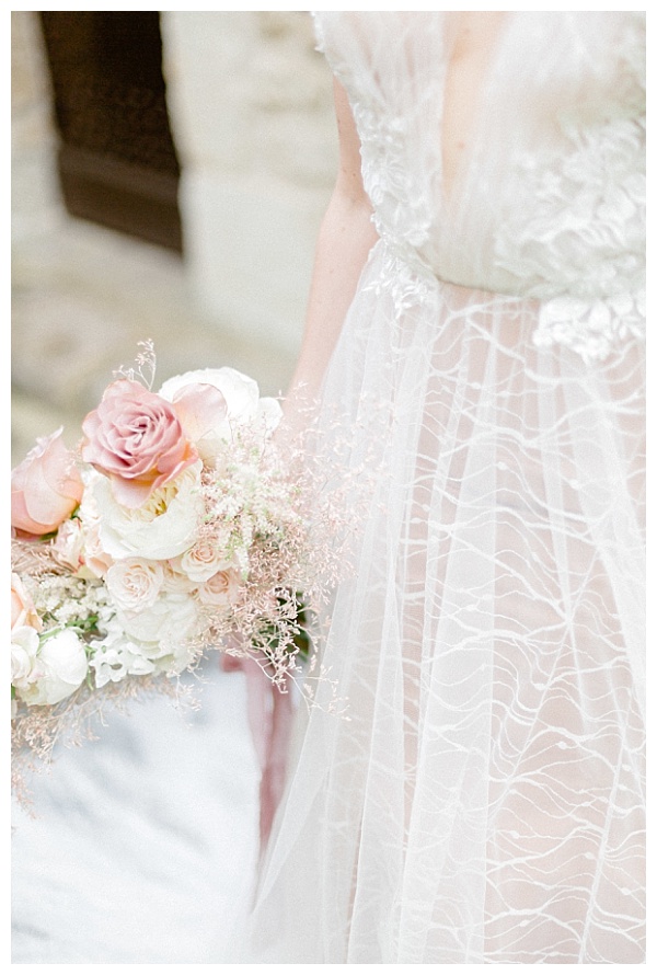 elegant white wedding dress and lovely rose boquet