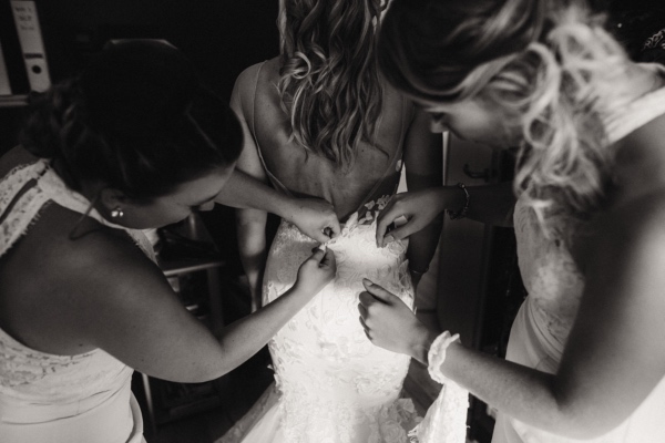 bridesmaids helping bride