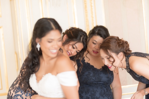 bridesmaids helping bride