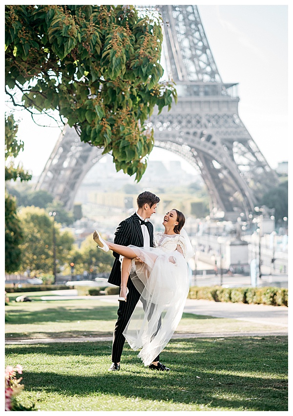 sweet couple dipping and twirling in front of the Eiffel Tower in Paris | Image by Helene Kos