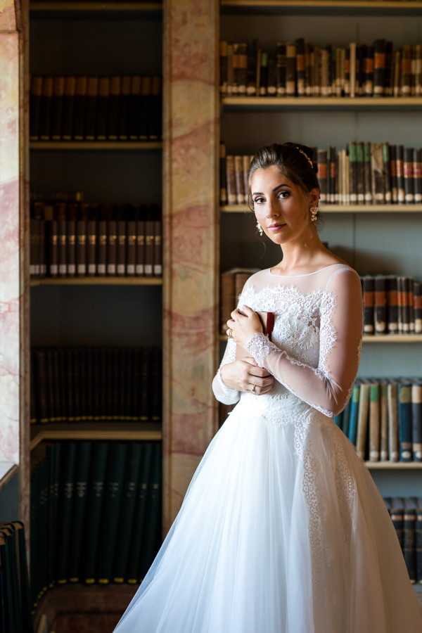 Bride holds book in Baroque library