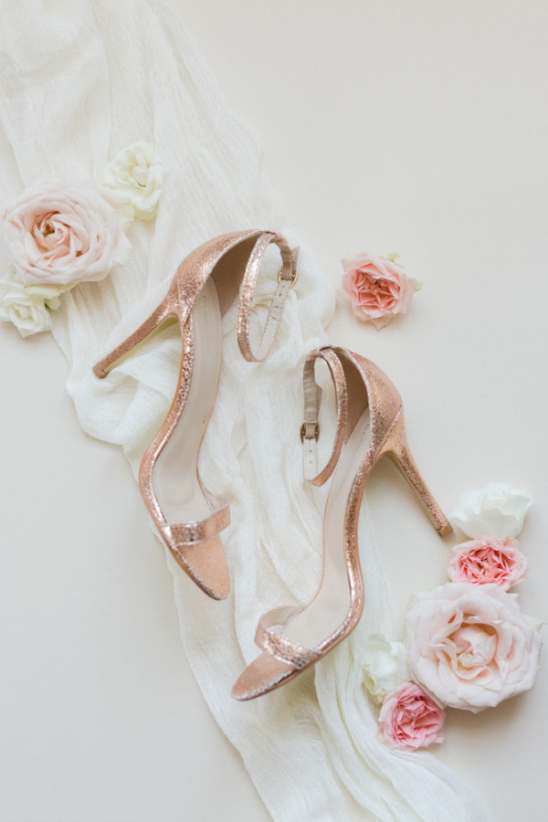 Bridal shoe flatlay with pastel wedding flowers