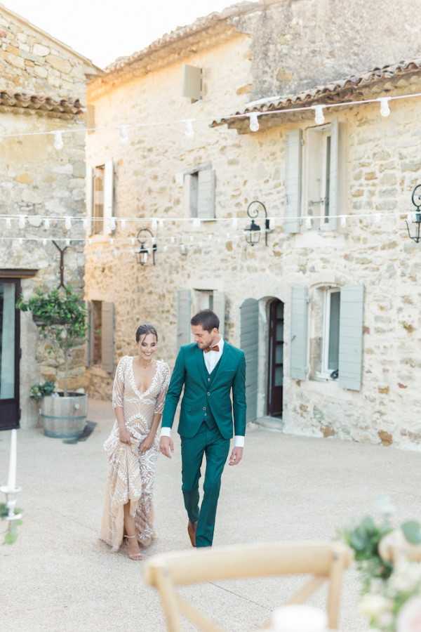 Bride and groom walk to pastel wedding table setting