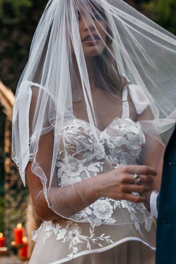 French bride in veil and lace white dress