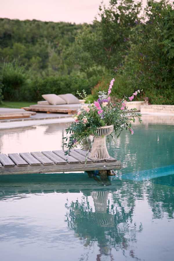 Pier with floral arrangement over infinity pool for wedding ceremony