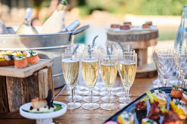 Champagne filled flutes with lavender flowers inside