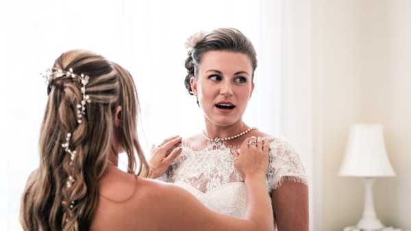 Bride with Pearl necklace and hair accessory gets ready for winter wedding