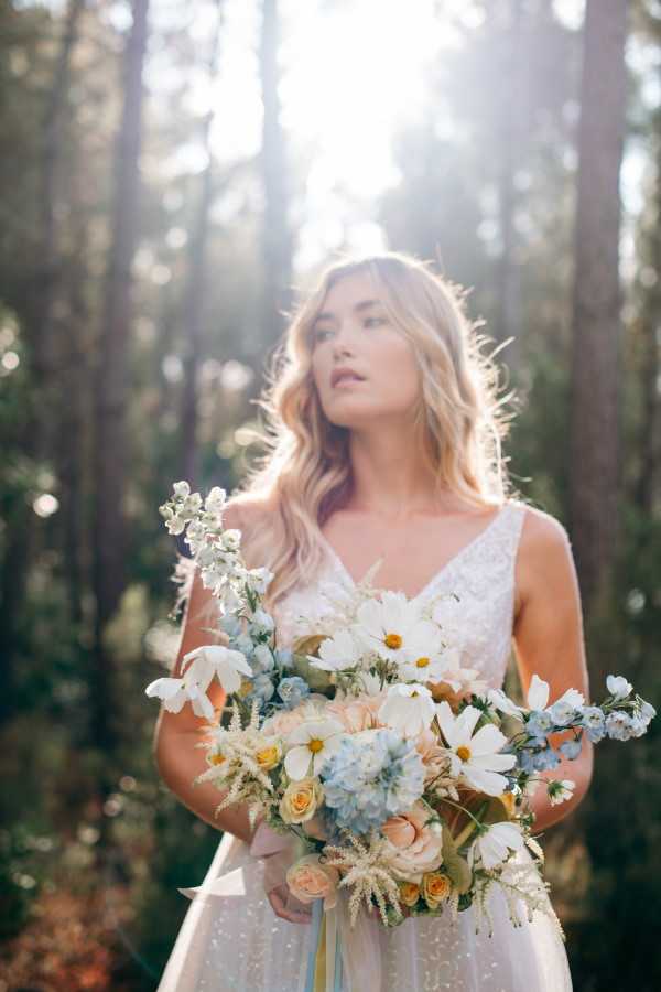 Bride holding bouquet in forest by the sea at Le Petit Nice