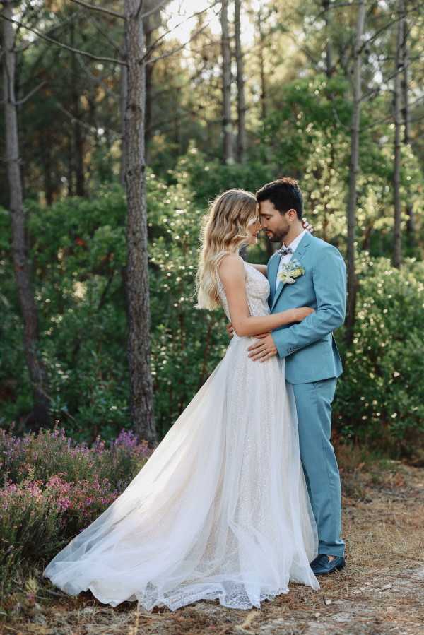 Bride and groom embrace where forest meets ocean at wedding in Le Petit Nice France