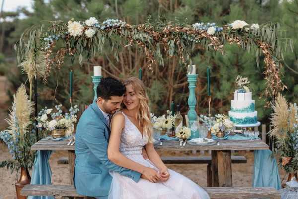 Couple in seated embrace by table at ocean wedding in Le Petit Nice