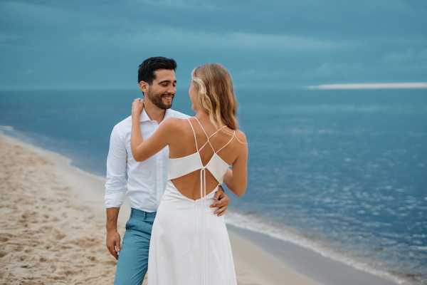 Bride in open back silk dress by the blue ocean of Le Petit Nice, France