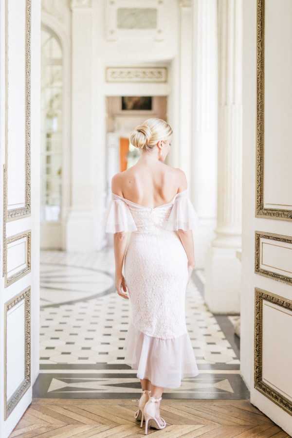 Bride walks away from camera in three quarter length gown and golden heels