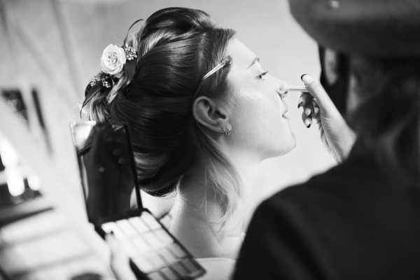 bride has makeup done before wedding 