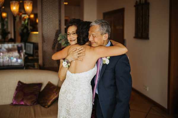 Bride hugs mother and father after the wedding