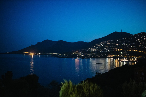 Evening lights sparkle over the water in the Cote d'Azur in France