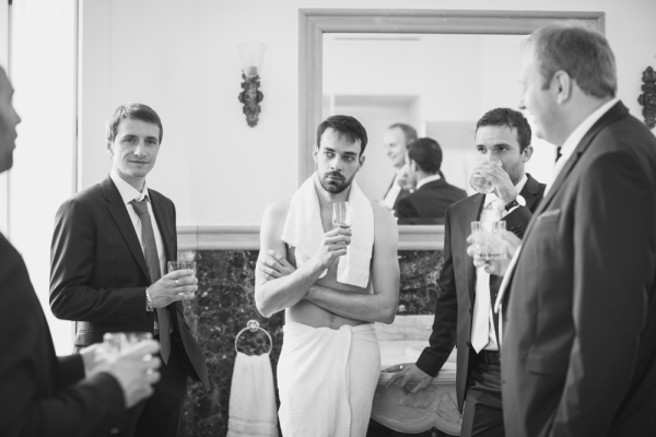 Groom and groomsmen getting ready in black and white