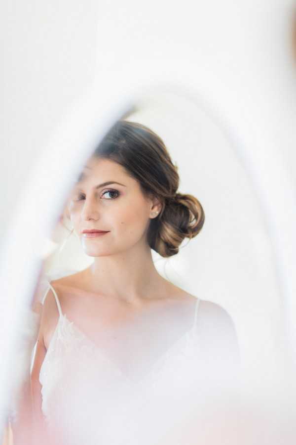 bride with up-do in mirror reflection