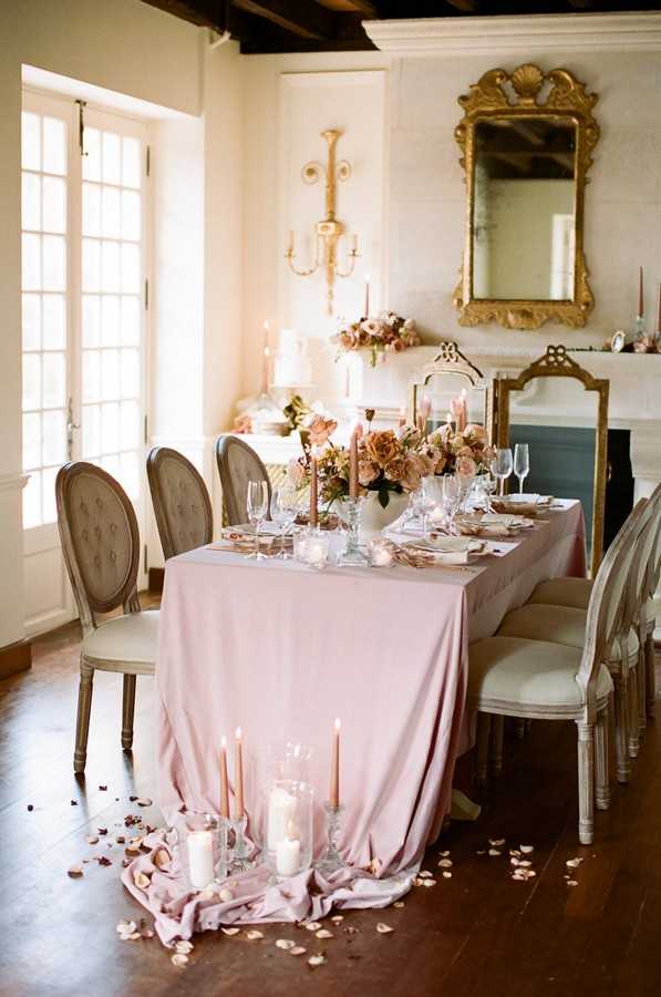 pink embellished dining table with candles and petals