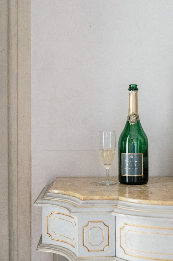 Champagne bottle and glass on side table