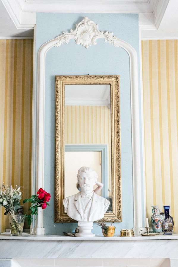 Fireplace, mirror and statue bust inside home in L'Isle-sur-la-Sorgue, France