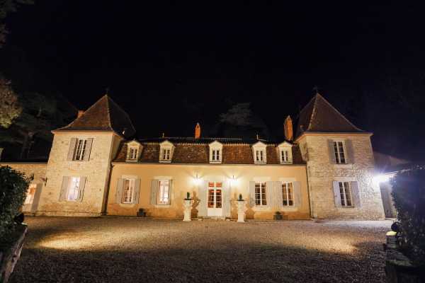 Chateau Lacanaud at night illuminated by uplights