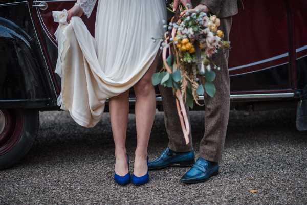 the bride and grooms feet both wearing blue shoes