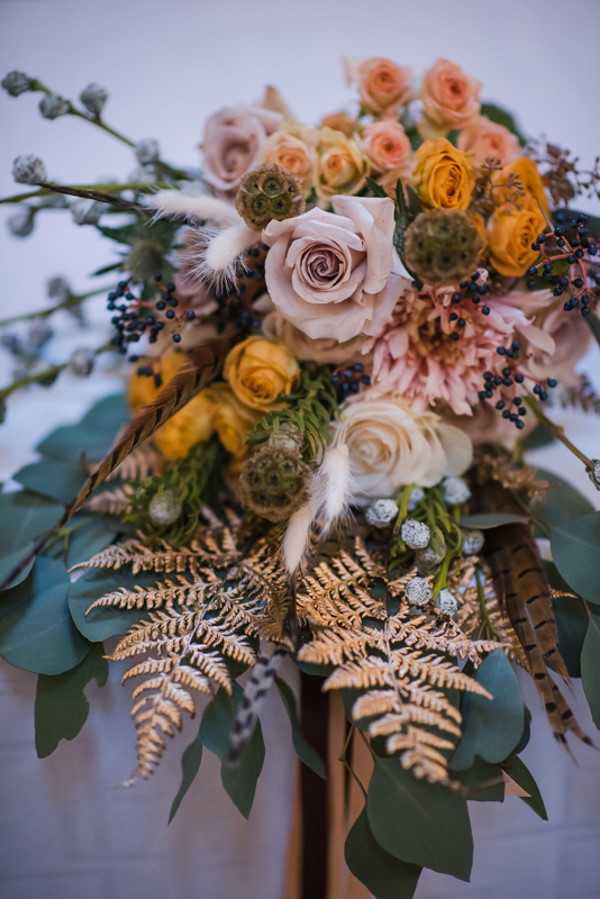 soft pink, orange, cream, brown and green make up this wedding bridal bouquet