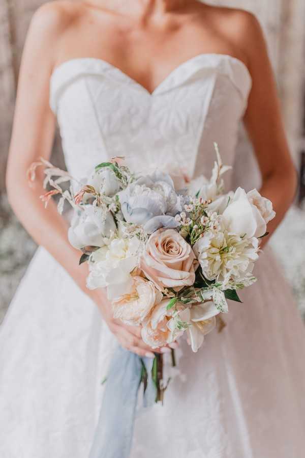 Bridal bouquet and strapless dress bust detailing