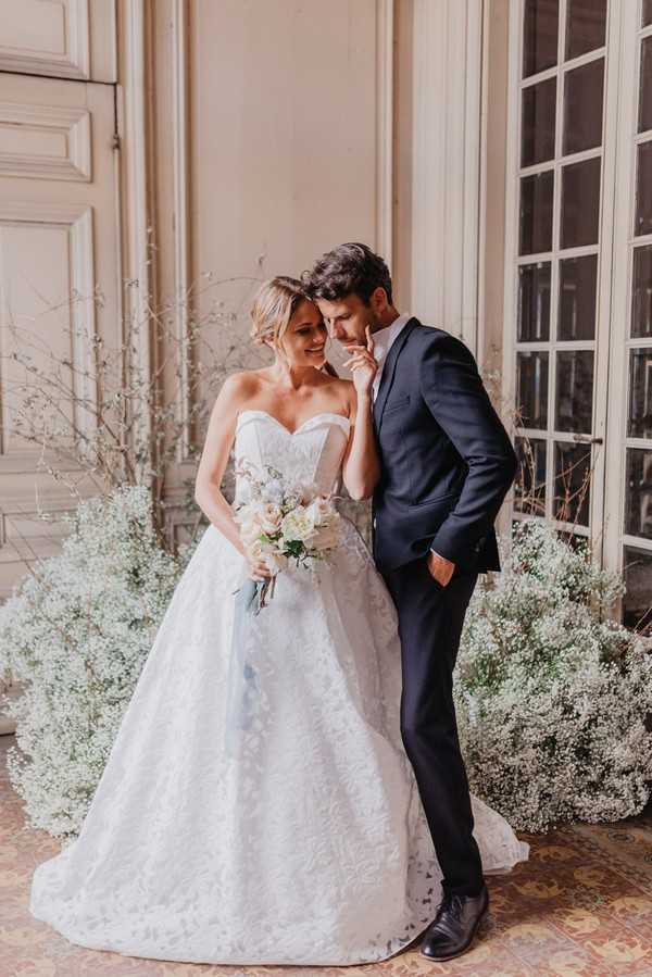 bride and groom surrounded by Baby's-breath flowers