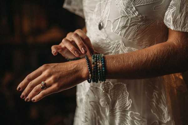 bride's arm with beaded green bracelets