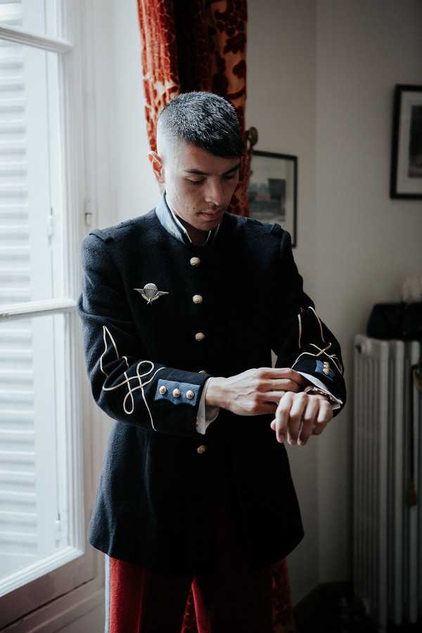 groom in military uniform gets ready for wedding