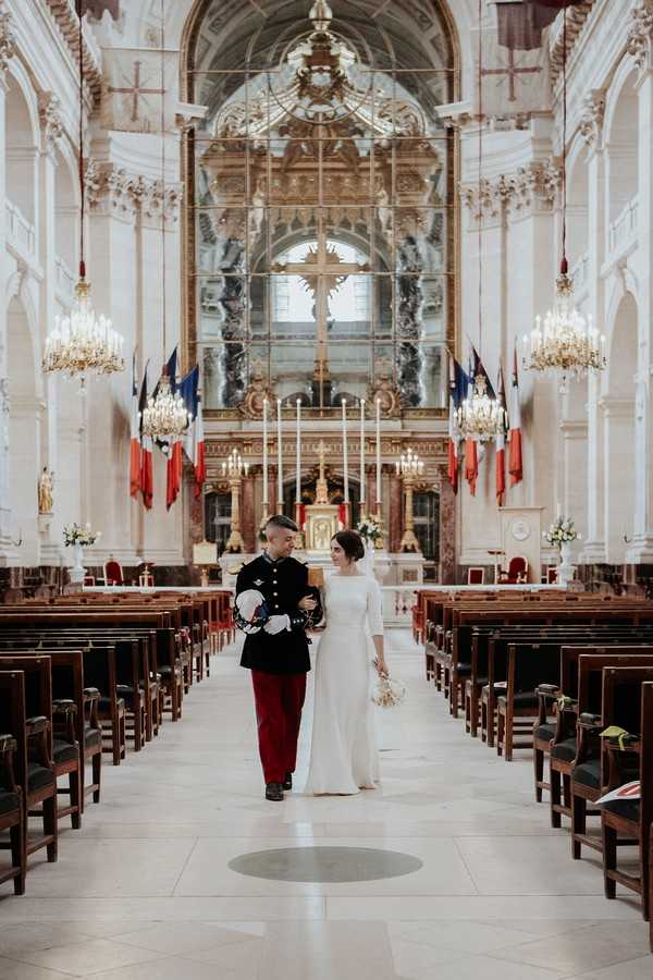 bride and groom walk back down the aisle of Cathedral of Saint Louis des Invalides after getting married