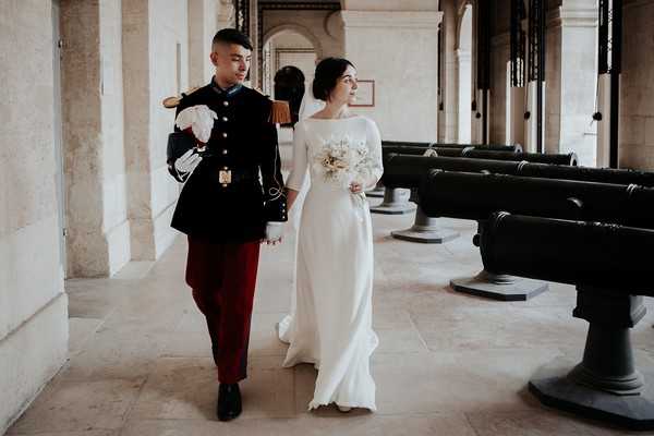 retro wedding over, the bride and groom walk through the grounds of Cathedral of Saint Louis des Invalides